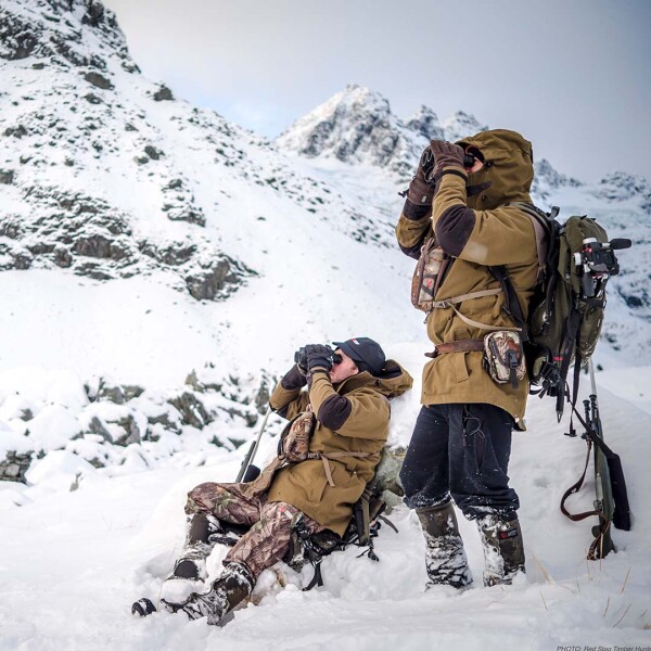 Alpine hunter scanning terrain